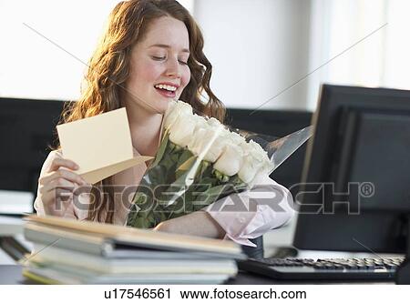Stock Image - Woman holding bouquet of flowers. Fotosearch