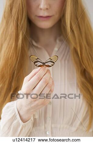 Stock Photo - Woman holding butterfly. Fotosearch