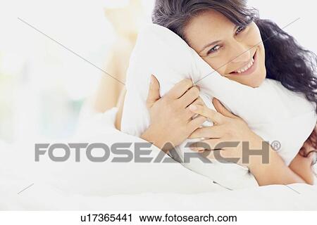 Woman holding pillow View Large Photo Image Stock Image - Woman holding pillow. Fotosearch
