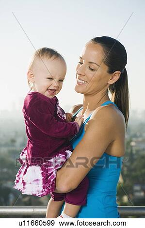 Woman holding toddler View Large Photo Image Stock Photo - Woman holding toddler. Fotosearch
