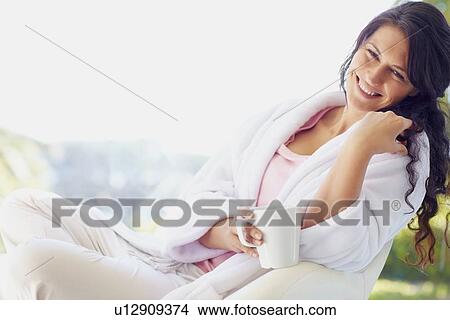 Woman in bathrobe drinking coffee View Large Photo Image Picture - Woman in bathrobe drinking coffee. Fotosearch