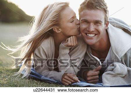 Stock Image - Woman kissing boyfriend. Fotosearch