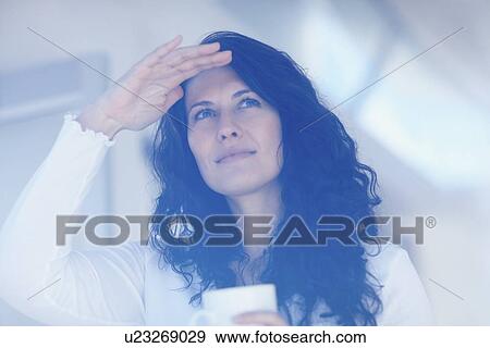 Woman looking out window View Large Photo Image Stock Photo - Woman looking out window. Fotosearch