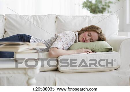 Stock Photography - Woman napping on couch. Fotosearch
