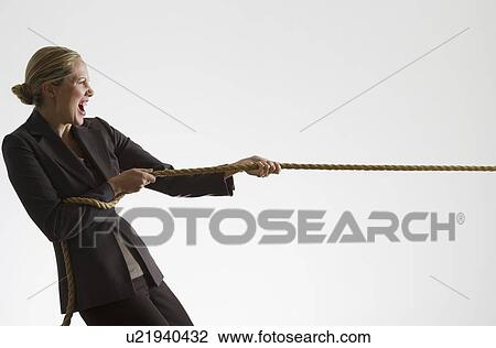Stock Image - Woman pulling a rope. Fotosearch