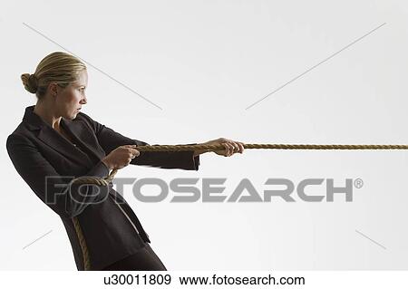 Woman pulling a rope View Large Photo Image Stock Photo - Woman pulling a rope. Fotosearch
