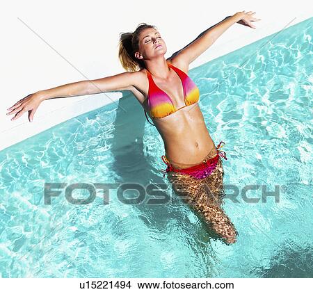 Picture - Woman relaxing in pool. Fotosearch