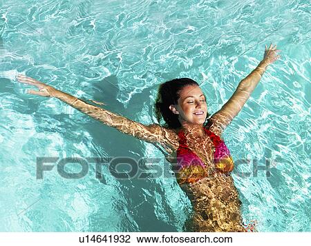 Woman relaxing in pool View Large Photo Image Stock Image - Woman relaxing in pool. Fotosearch