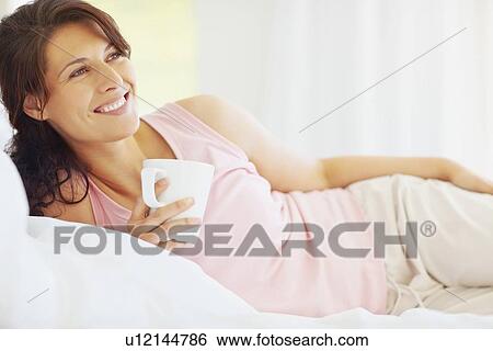 Woman relaxing with a coffee View Large Photo Image Stock Photograph - Woman relaxing with a coffee. Fotosearch