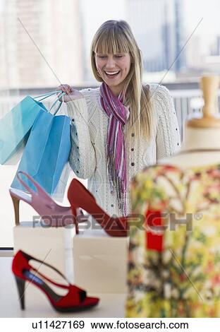 Stock Photo - Woman shopping for shoes. Fotosearch