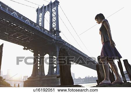 Woman standing near bridge View Large Photo Image Stock Image - Woman standing near bridge. Fotosearch
