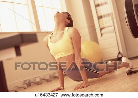 Stock Photo - Woman stretching during a workout. Fotosearch