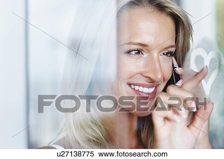 Stock Photography - Woman talking on cellular phone. Fotosearch