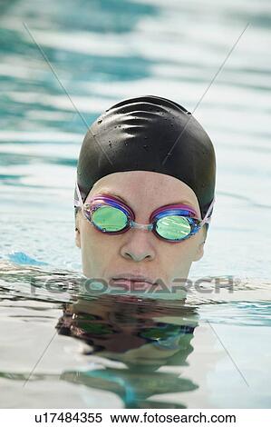 Stock Photography - Woman wearing bathing cap and swimming goggles. Fotosearch
