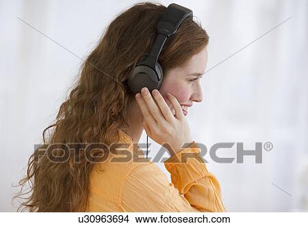 Picture - Woman wearing headphones. Fotosearch