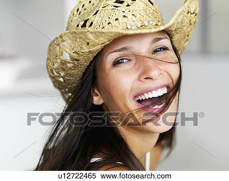 Stock Photography - Woman wearing straw hat. Fotosearch