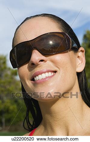 Stock Image - Woman wearing sunglasses. Fotosearch