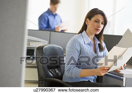 Stock Photo - Woman working in cubicle. Fotosearch