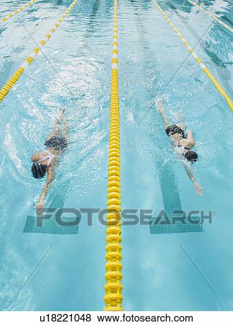 Stock Photo - Women swimming laps in pool. Fotosearch