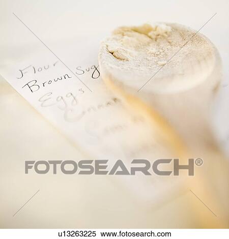 Wooden spoon on top of shopping list View Large Photo Image Stock Photography - Wooden spoon on top of shopping list. Fotosearch
