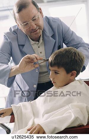 Young boy getting a haircut View Large Photo Image Stock Photography - Young boy getting a haircut. Fotosearch