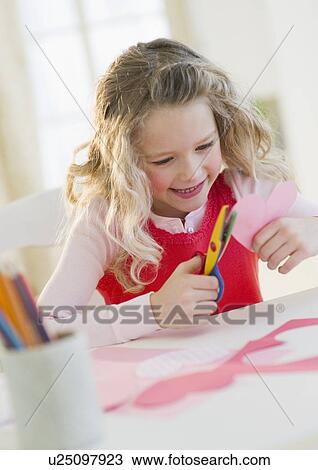 Young girl cutting our hearts View Large Photo Image Stock Image - Young girl cutting our hearts. Fotosearch