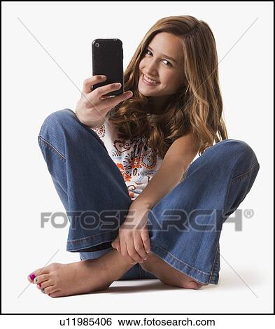 Young girl holding cellular phone View Large Photo Image Stock Photograph - Young girl holding cellular phone. Fotosearch