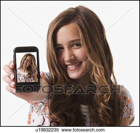 Stock Photography - Young girl holding cellular phone. Fotosearch