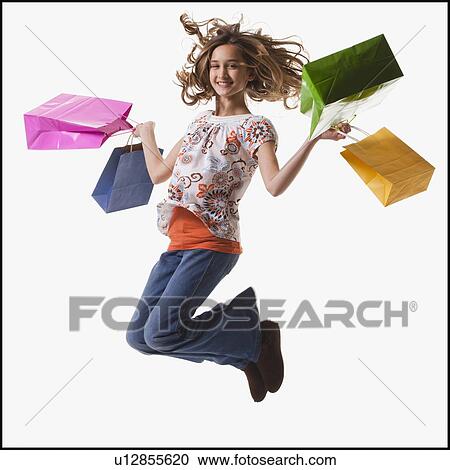 Stock Image - Young girl holding shopping bags. Fotosearch