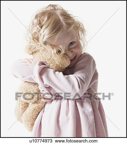 Young girl hugging teddy bear View Large Photo Image Stock Image - Young girl hugging teddy bear. Fotosearch