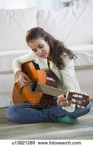 Young girl playing guitar View Large Photo Image Stock Photo - Young girl playing guitar. Fotosearch