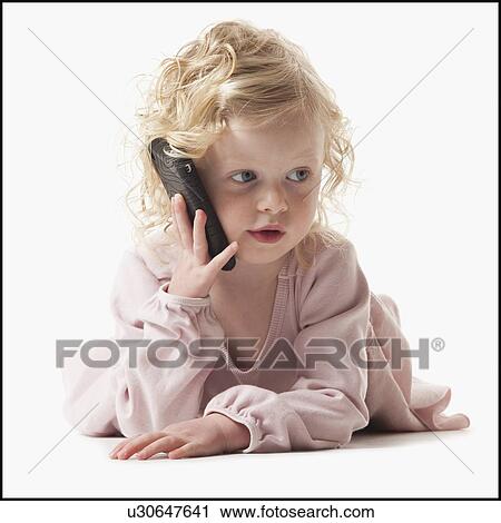 Young girl playing with a cellular phone View Large Photo Image Stock Image - Young girl playing with a cellular phone. Fotosearch
