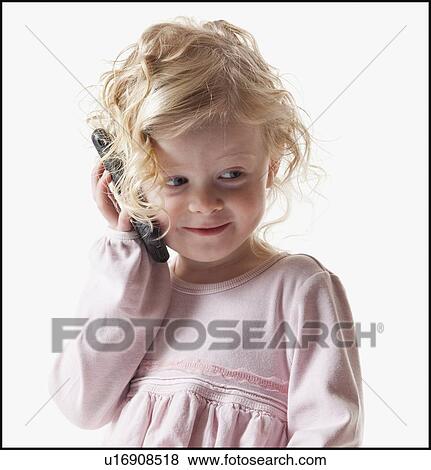 Young girl playing with a cellular phone View Large Photo Image Stock Photo - Young girl playing with a cellular phone. Fotosearch