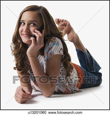 Young girl talking on cell phone View Large Photo Image Stock Image - Young girl talking on cell phone. Fotosearch