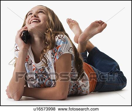 Young girl talking on cell phone View Large Photo Image Stock Photo - Young girl talking on cell phone. Fotosearch