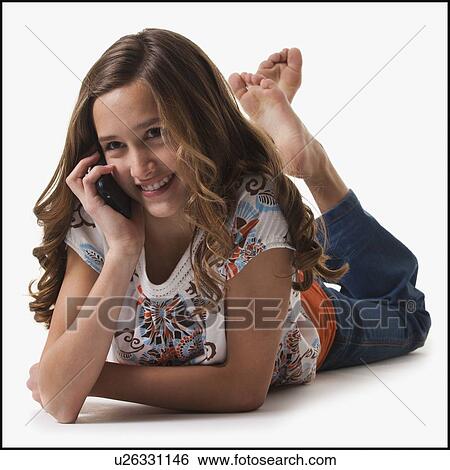 Stock Photograph - Young girl talking on cell phone. Fotosearch