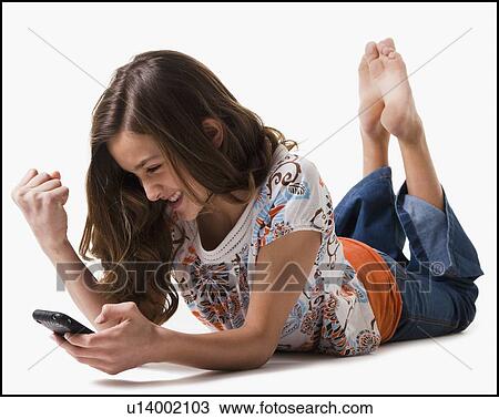 Stock Image - Young girl texting. Fotosearch