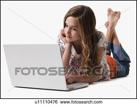 Young girl using laptop View Large Photo Image Stock Photograph - Young girl using laptop. Fotosearch