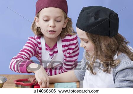 Stock Photograph - Young girls baking. Fotosearch
