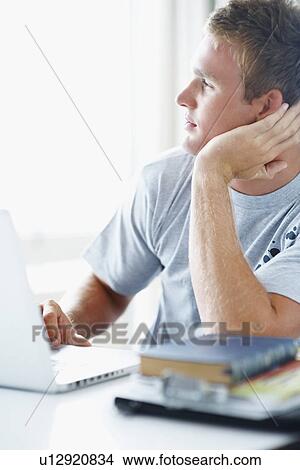 Picture - Young man daydreaming. Fotosearch