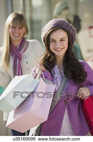 Young woman with shopping bags View Large Photo Image Stock Photo - Young woman with shopping bags. Fotosearch