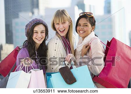 Young women with shopping bags View Large Photo Image Stock Image - Young women with shopping bags. Fotosearch