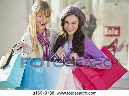 Young women with shopping bags View Large Photo Image Stock Photo - Young women with shopping bags. Fotosearch