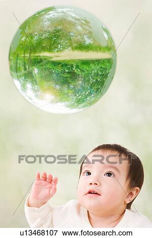 Stock Photo - A baby and Globe. Fotosearch
