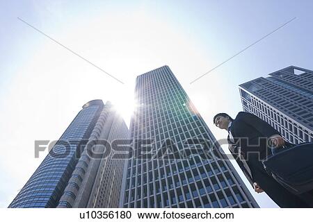 Stock Image - A businessman in business district. Fotosearch