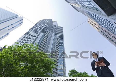 A businessman in business district View Large Photo Image Stock Image - A businessman in business district. Fotosearch
