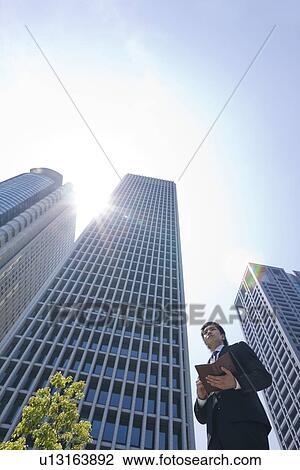 A businessman in business district View Large Photo Image Stock Image - A businessman in business district. Fotosearch