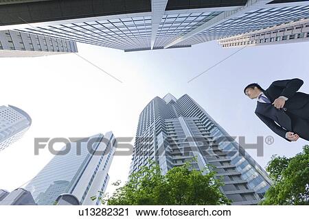 A businessman in business district View Large Photo Image Stock Image - A businessman in business district. Fotosearch