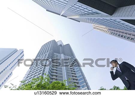 Stock Photo - A businessman in business district. Fotosearch