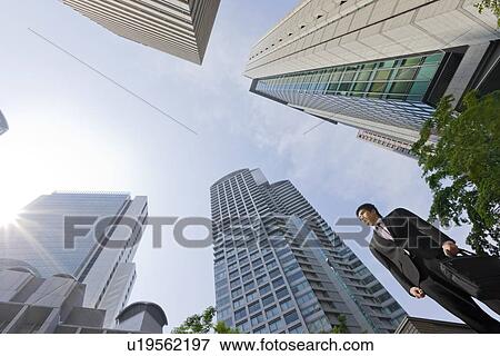Stock Photo - A businessman in business district. Fotosearch